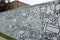 Long cement wall with artist`s drawings of interesting things around town, Geneva, New York, 2018