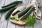 Long Chinese cucumbers on a cutting board while slicing salad. wood background