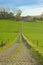 Long cobblestone road towards a castle in the hills of Flemish Ardennes