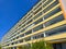 Long communist style block of flats with huge terrace like balconies