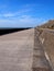 long concrete pedestrian walkway along the seawall in blackpool lancashire with summer sunshine and sea