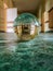 Long corridor with green covering on the floor reflected in crystal glassy lensball in old hospital