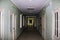 A Long corridor in the hospital. A corridor with doors and windows