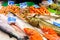 Long counter with various fish and shellfish in market. Barcelona.