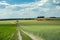 Long country road from above through farmland