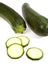 LONG COURGETTE OR ZUCCHINI AGAINST WHITE BACKGROUND