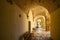 A long, covered and arched portico hallway in the historic center of Brindisi, Italy