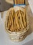 Long Crispy Breadsticks inside a Wicker Basket