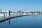 Long curving pier surrounded by blue calm water