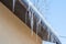 Long and dangerous icicles hanging from roof of house. Winter season concept. Frost and snow weather