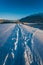 Long deep snow trail path to traditional Austrian house in sunlit alpine winter landscape in Wildermieming  Tirol  Austria