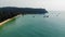 Long deserted beach with white sand and clear water. Aerial top view. Coast of island Koh Rong Samloem, Cambodia