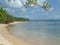 A long deserted white sand beach next to the turquoise sea