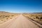 Long, desolate dirt road in te Utah desert.