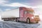 Long-distance bonnet truck with a white semitrailer on bright background with sky