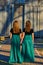 Long dress twin teen sisters hand in hand