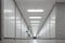 Long empty illuminated interior hallway. Vanishing perspective, bright neon lights, vertical cabinets lined side wall. Underground