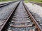 Long empty railroad tracks go into the distance, travel concept