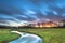 Long Exposue Sunset with Blurred Clouds over River Landscape