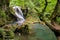 Long exposure of the beautiful La Vaioaga waterfall with green moss, Beusnita, Cheile Nerei National Park, Caras Severin, Romania