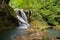 Long exposure of the beautiful La Vaioaga waterfall with green moss, Beusnita, Cheile Nerei National Park, Caras Severin, Romania