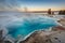 Long exposure of Black Pool at West Thumb Geyser Basin Trail during wonderful colorful sunset, Yellowstone National Park