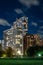 Long exposure of clouds moving across a dark blue sky over modern residential highrise buildings in the Lakeview neighborhood