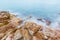 Long exposure of dreamy seascape and rocky beach