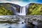 Long exposure of famous Skogafoss waterfall in Iceland at dusk