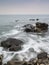 Long exposure flowing tide over rocks
