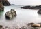 Long exposure flowing tide over rocks