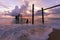 Long exposure image of Dramatic sky seascape with Old wooden pole in the sea sunset or sunrise scenery background