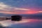 Long exposure of magic sunrise over the ocean with a hut in the