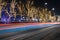 Long exposure night city light festive street urban view colorful illumination from fuzzy cars headlights and garlands on trees