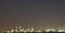 Long exposure night photo crude oil refinery plant and many chimney with petrochemical tanker or cargo ship at coast of the river