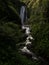 Long exposure panorama of tropical lush green protected forest waterfall cascade Peguche in Otavalo Imbabura Ecuador