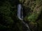 Long exposure panorama of tropical lush green protected forest waterfall cascade Peguche in Otavalo Imbabura Ecuador