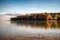 Long exposure photo of colorful autumn leaves on trees on coast of lake Liptovska Mara, Slovakia: Beautiful waterscape