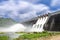 Long exposure photo of water release at spillway or overflows at big dam with blue sky and clouds Khun Dan Prakan Chon dam in