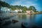 Long exposure picture of S`Alguer beach with its typical painted doors in Costa Brava