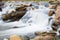 Long exposure picture of a small cold waterfalls through boulders in Snowdonia, Wales