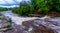 Long exposure of raging water cascading down river