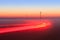 Long Exposure Red Car light trails on a road outside at foggy night on blue hour