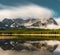 Long exposure reflection with lake and mountains low hanging couds in Lower Kananaskis Lake of Peter Lougheed Provincial