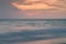 A long exposure of the sea at golden hour, as dawn breaks