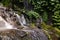 Long exposure shot of Banyumala waterfal with pile of stones