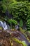 Long exposure shot of Banyumala waterfal with pile of stones