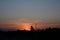 Long exposure shot of a charming sky at sunset in orange and dark blue colors with shadowed trees