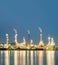 long exposure shot of oil refinery plant against blue evening sk