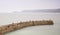 Long exposure sunset image of harbour wall curving into image